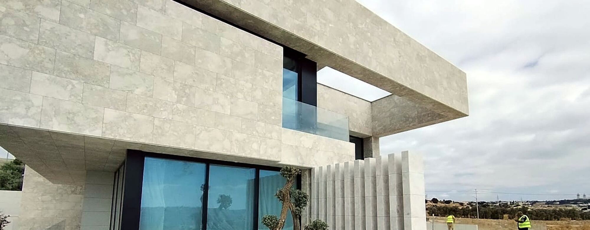 A completed natural-stone villa in Amman with a cantilevered upper floor